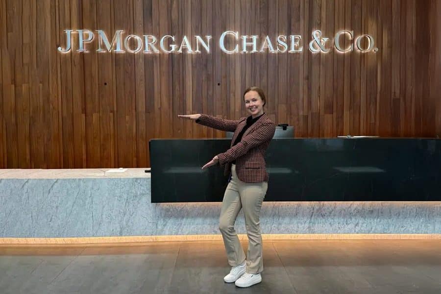 Emily Storr doing the Gator Chomp in front of a JPMorganChase sign