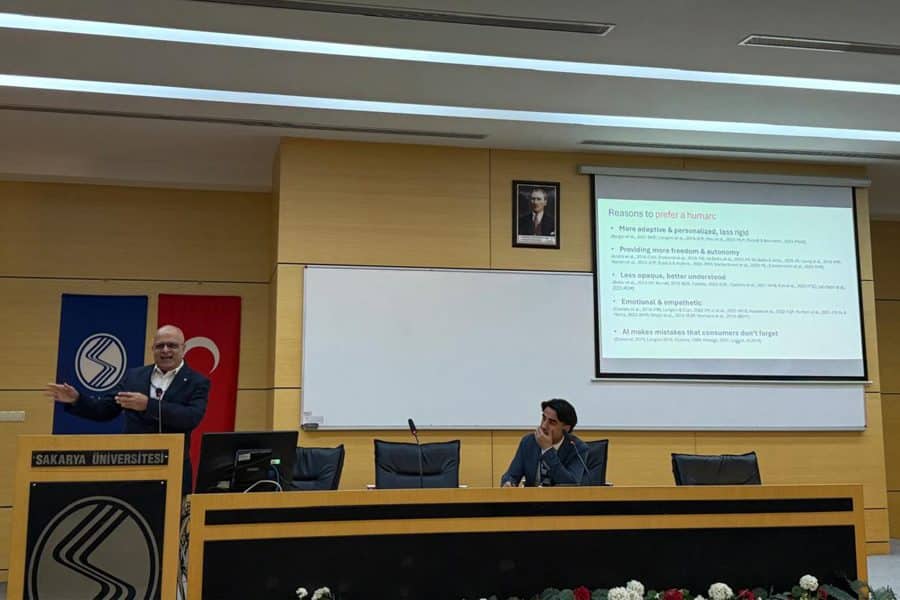 rahul banerjee presenting academic research paper behind a podium at gitma conference