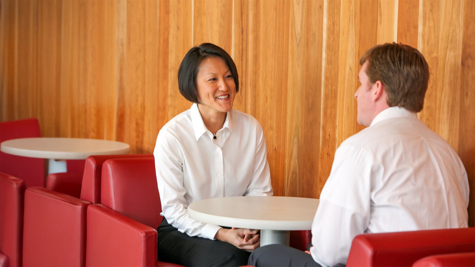 A student and recruiter share a one-on-one conversation in a casual lounge setting.