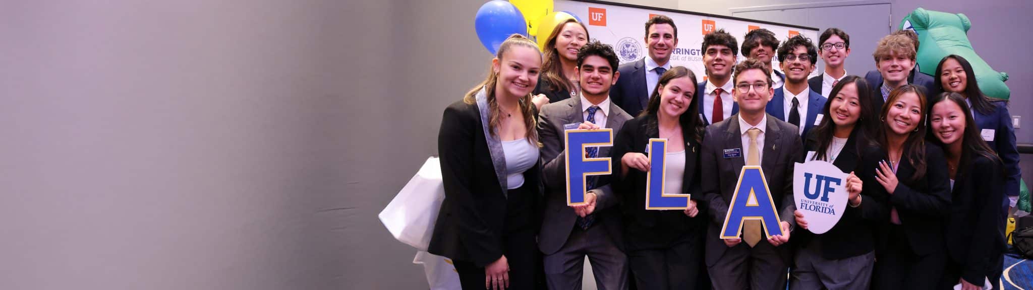 A group photo of students holding up the letters "FLA"