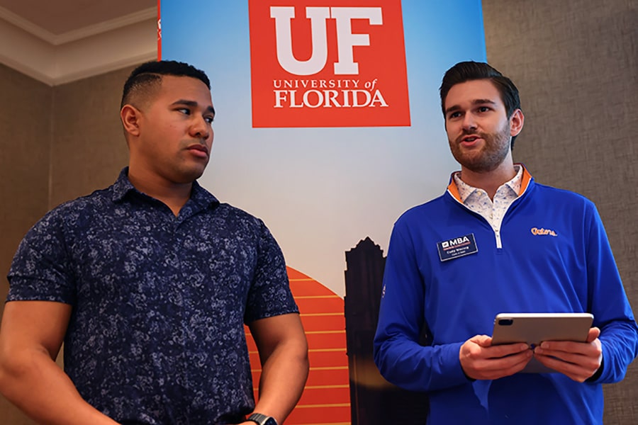 Closeup of two MBA students taking part in a group presentation.