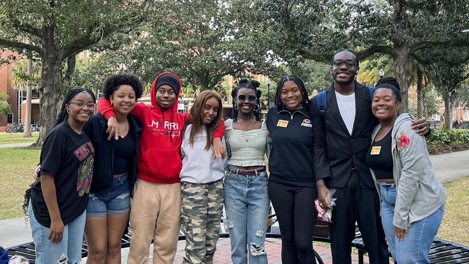 Group of smiling NABA student members pose together outdoors on UF’s campus
