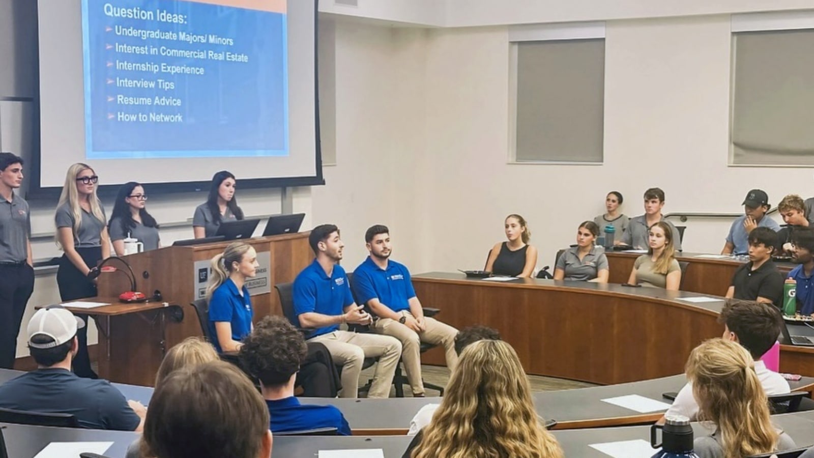 Students and guest speakers engage in a real estate panel discussion at UF