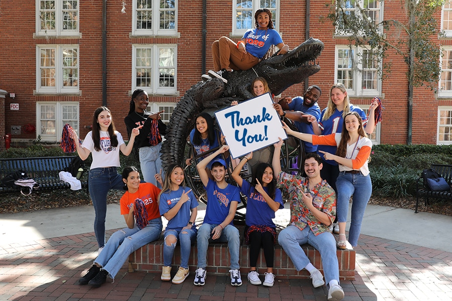 Students holding a "Thank You" sign. 