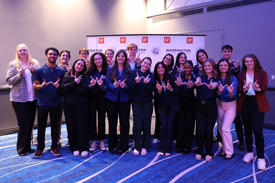 A group of students holding up a "W" with their hands at the Warrington Welcome Professional Development Summit. 