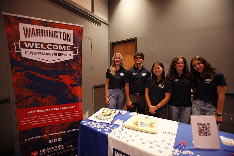 Students at a Warrington Welcome event booth.