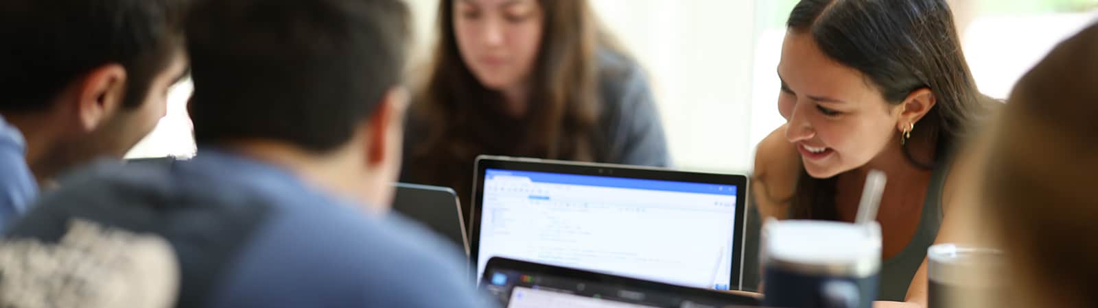 Close up of group of students studying with their laptops.