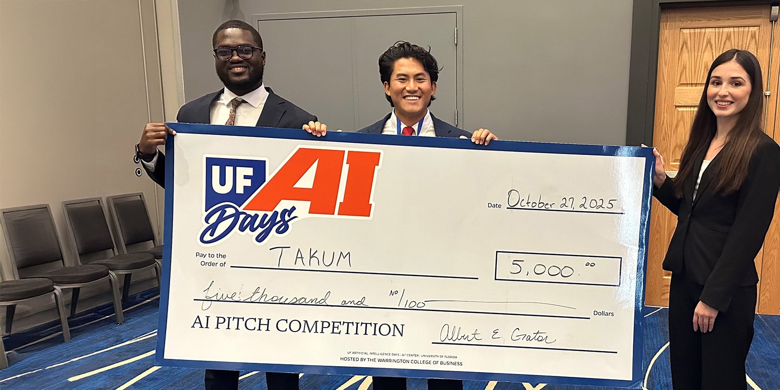 Three students representing TAKUM hold the UF AI Days giant winner check for $5,000.