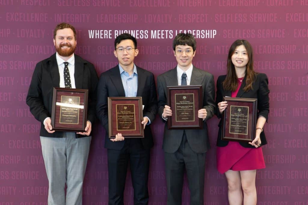 Qili Wang, second from right, at the Texas A&M Best Dissertation Proposal in AI Business Research Ceremony poses with three fellow award winners.