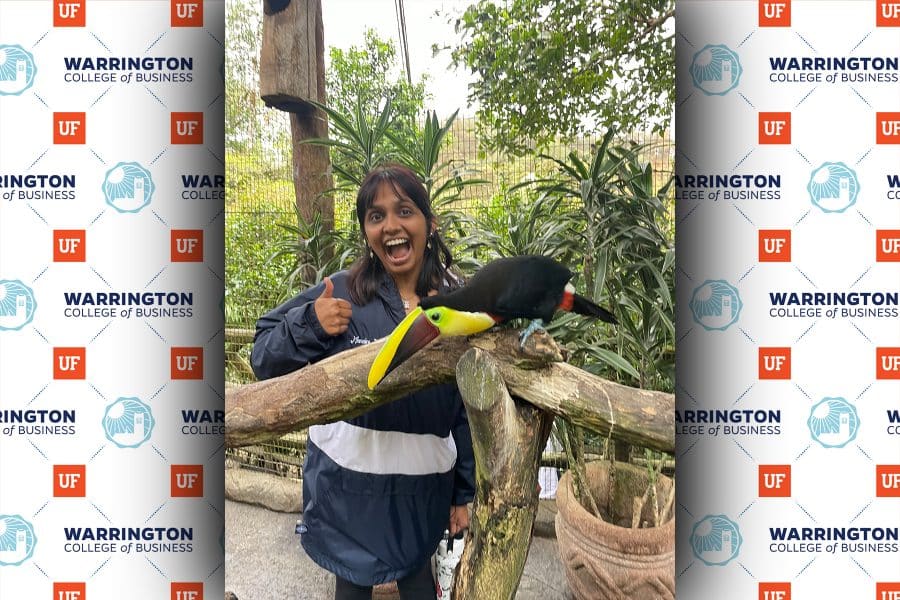 Nandini Kumar smiling wiht her thumbs up with a toucan in Costa Rica on GIE trip