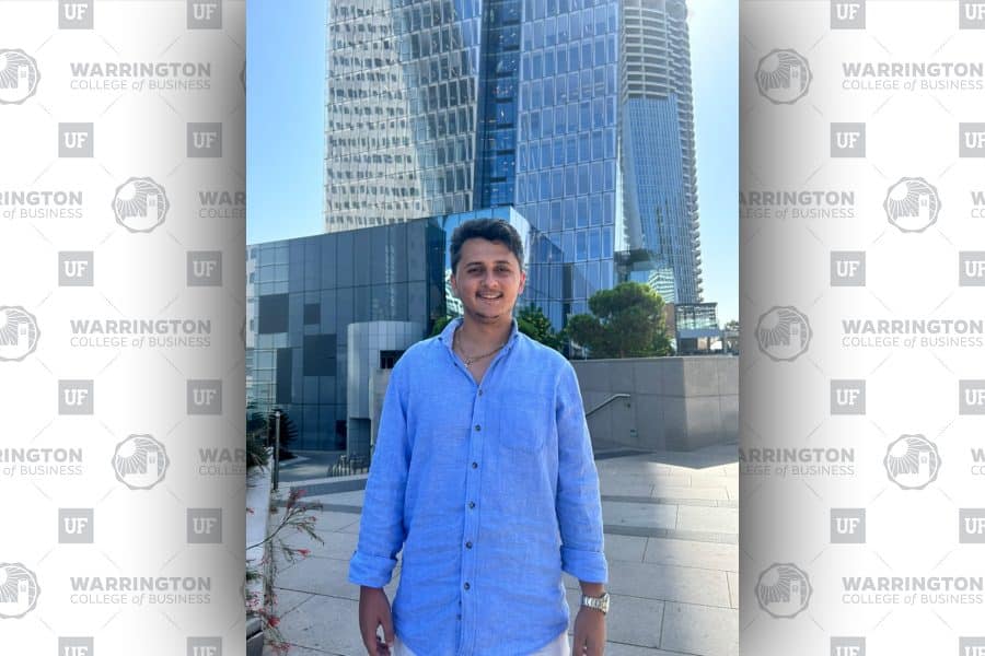max wahba smiling standing in front of a city building