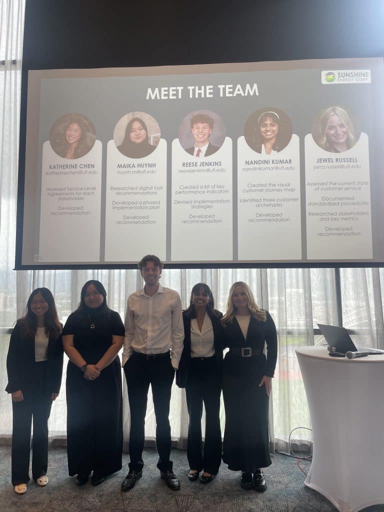 Nandini Kumar standing with a team smiling