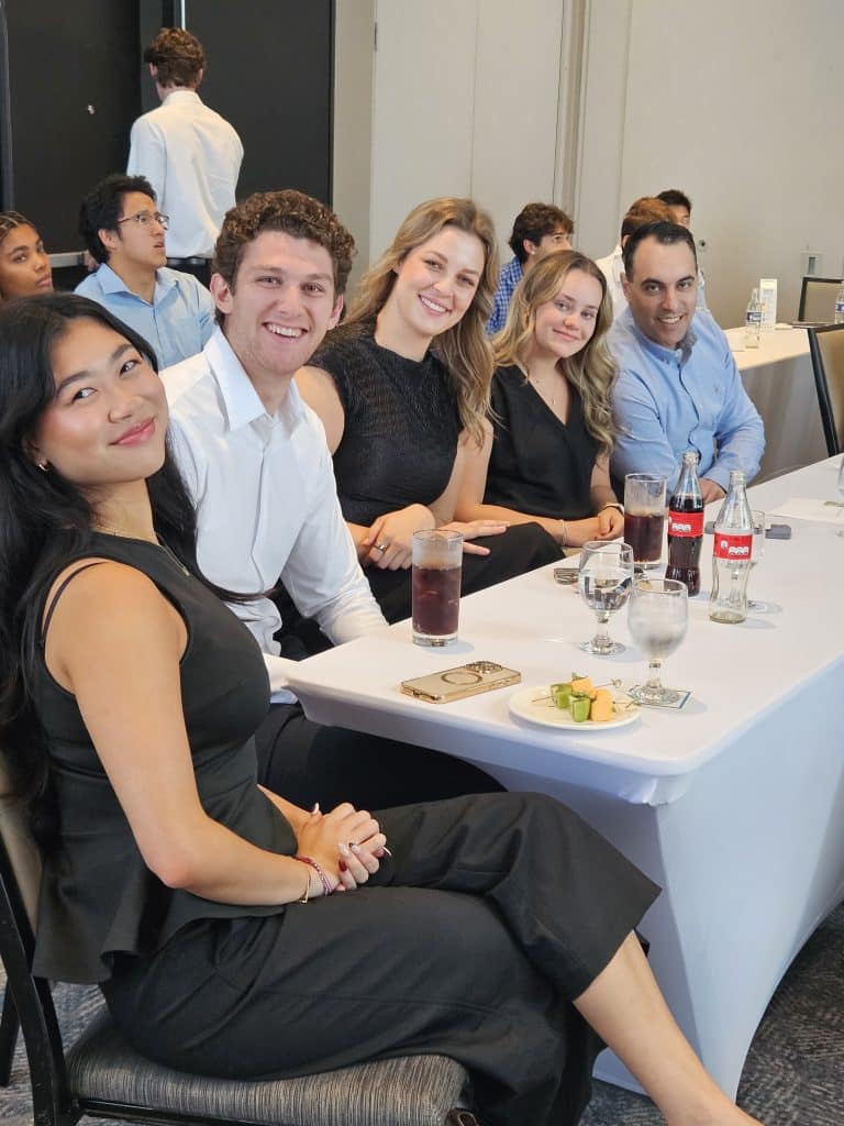 Adonis Giannopoulos sitting at table with MIB team in Costa Rica