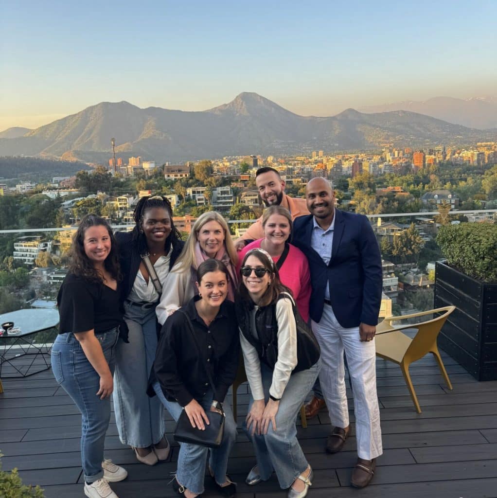 MBA student team in Chile standing on a balcony with a mountain background
