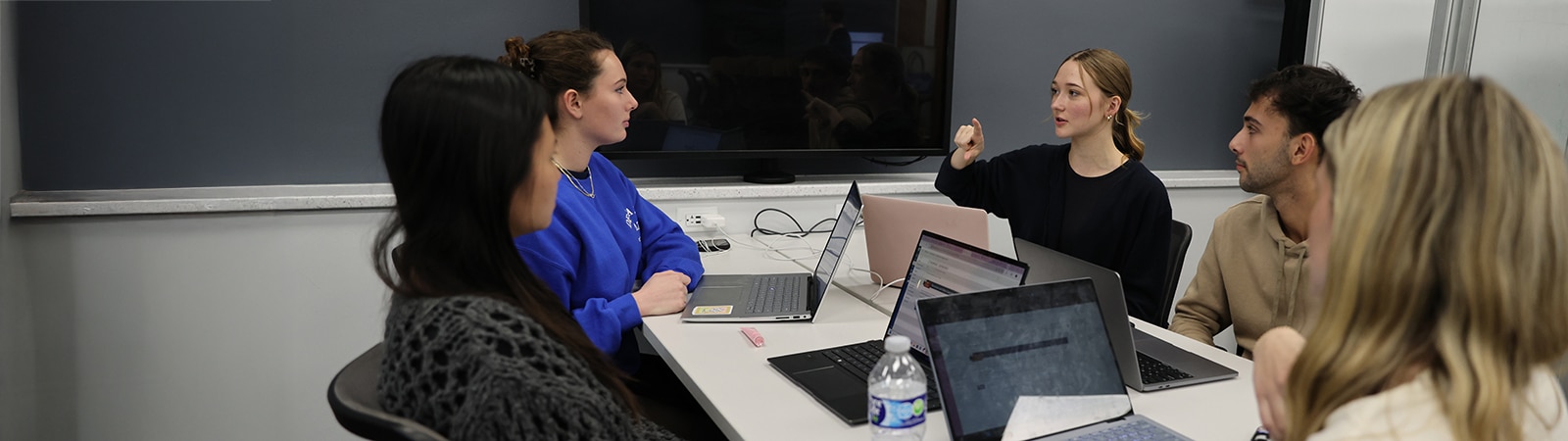 Happy students working together in a classroom.