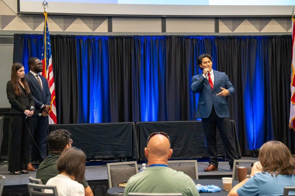 Imsulen “Allen” Jamir, Réka Holicsek and Samuel Frempong on stage pitching TAKUM.