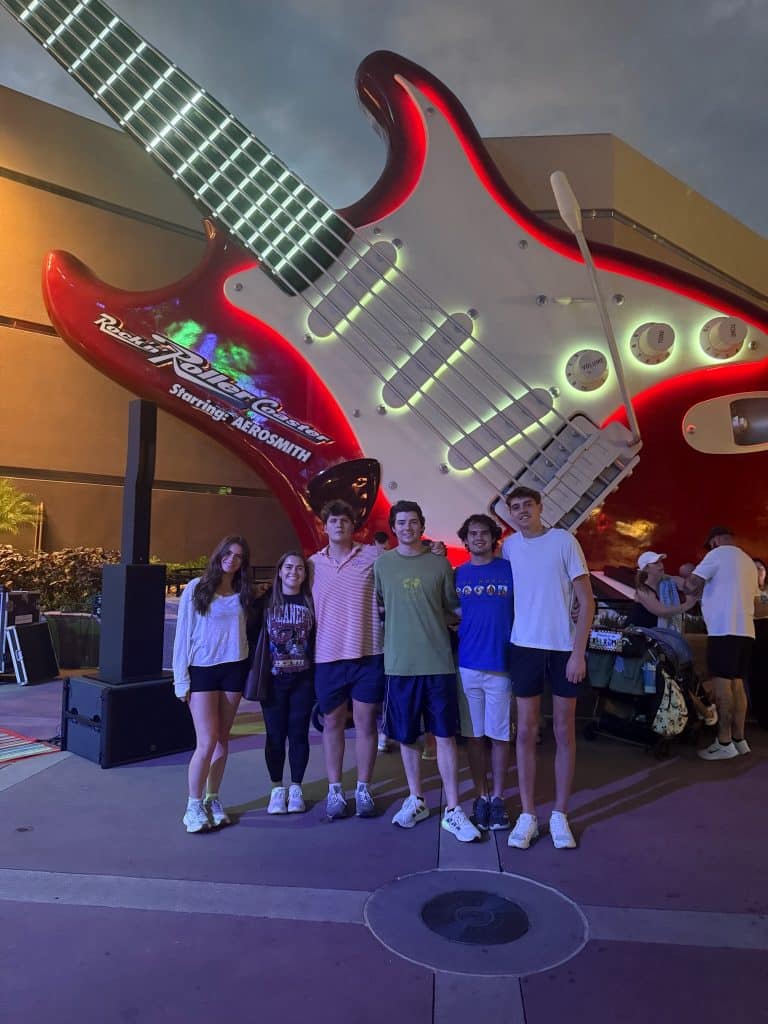UF sales team standing together in front of the Rockin Roller Coaster guitar in Hollywood Studios, Disney World