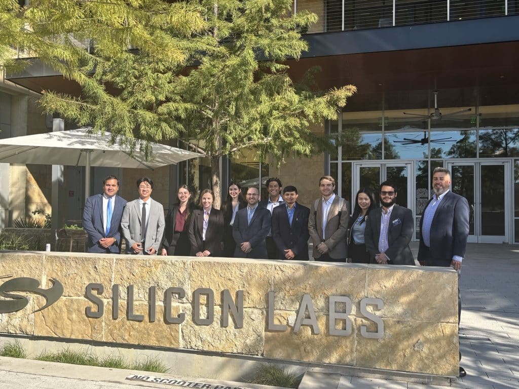 Students in Mike Carillo's MAN6930 Fall 2025 Pose in front of a Silicon Labs sign.