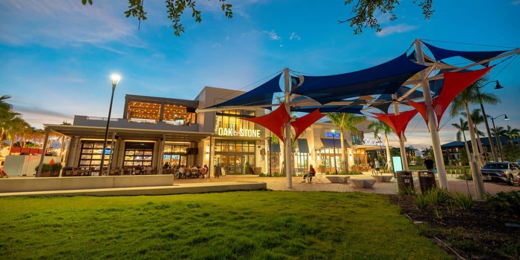 Oak and Stone restaurant with outdoor seating and shade sails at Wellen Park