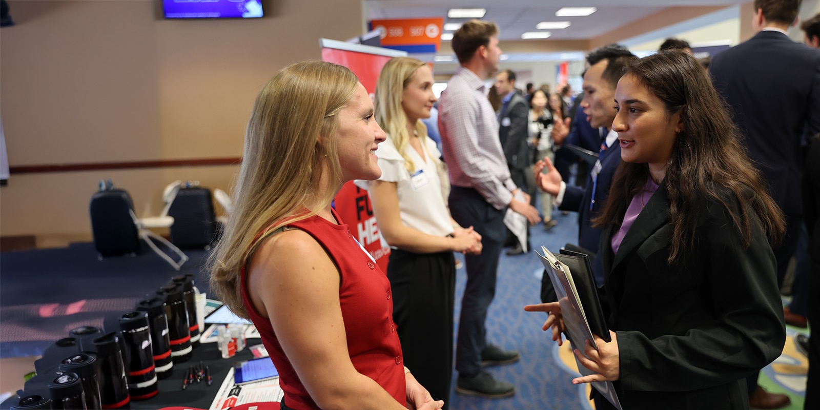 Student speaking with a recruiter at the Warrington Career Expo event. 