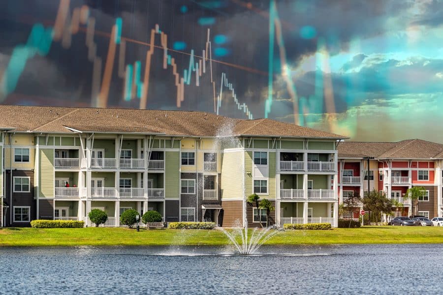 Apartment buildings with a retention pond in the foreground and chart lines overlaid on the sky in the background