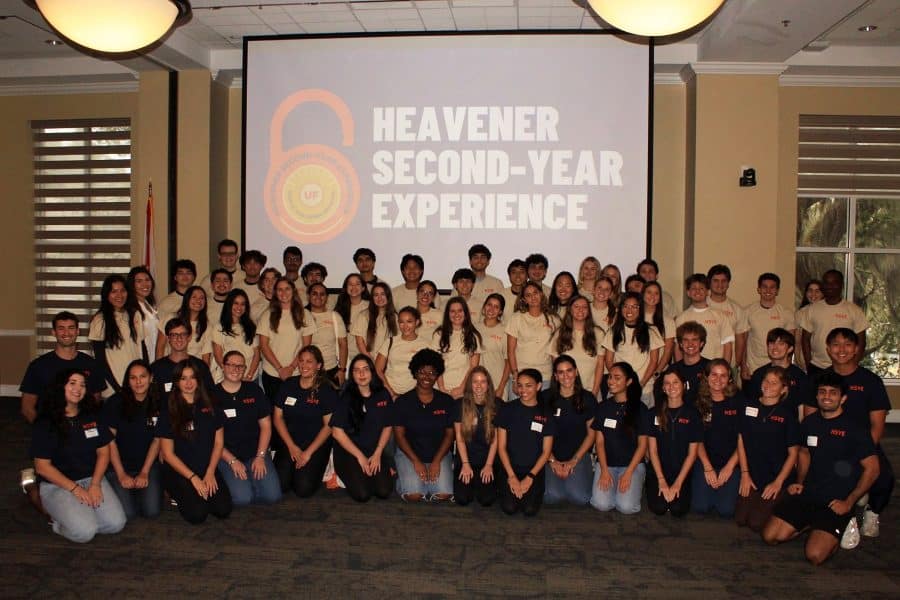 heavener second year experience students sitting and standing in front of a HSYE sign for a group photo