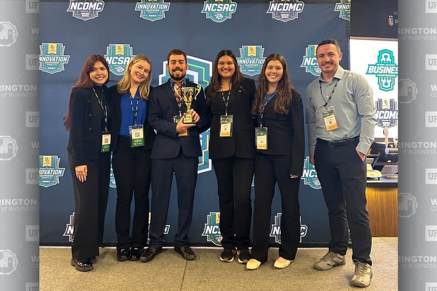 2026 National Collegiate Digital Marketing Championship team standing with the trophy